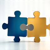 Mergers and acquisitions icon or image representing two merging entities